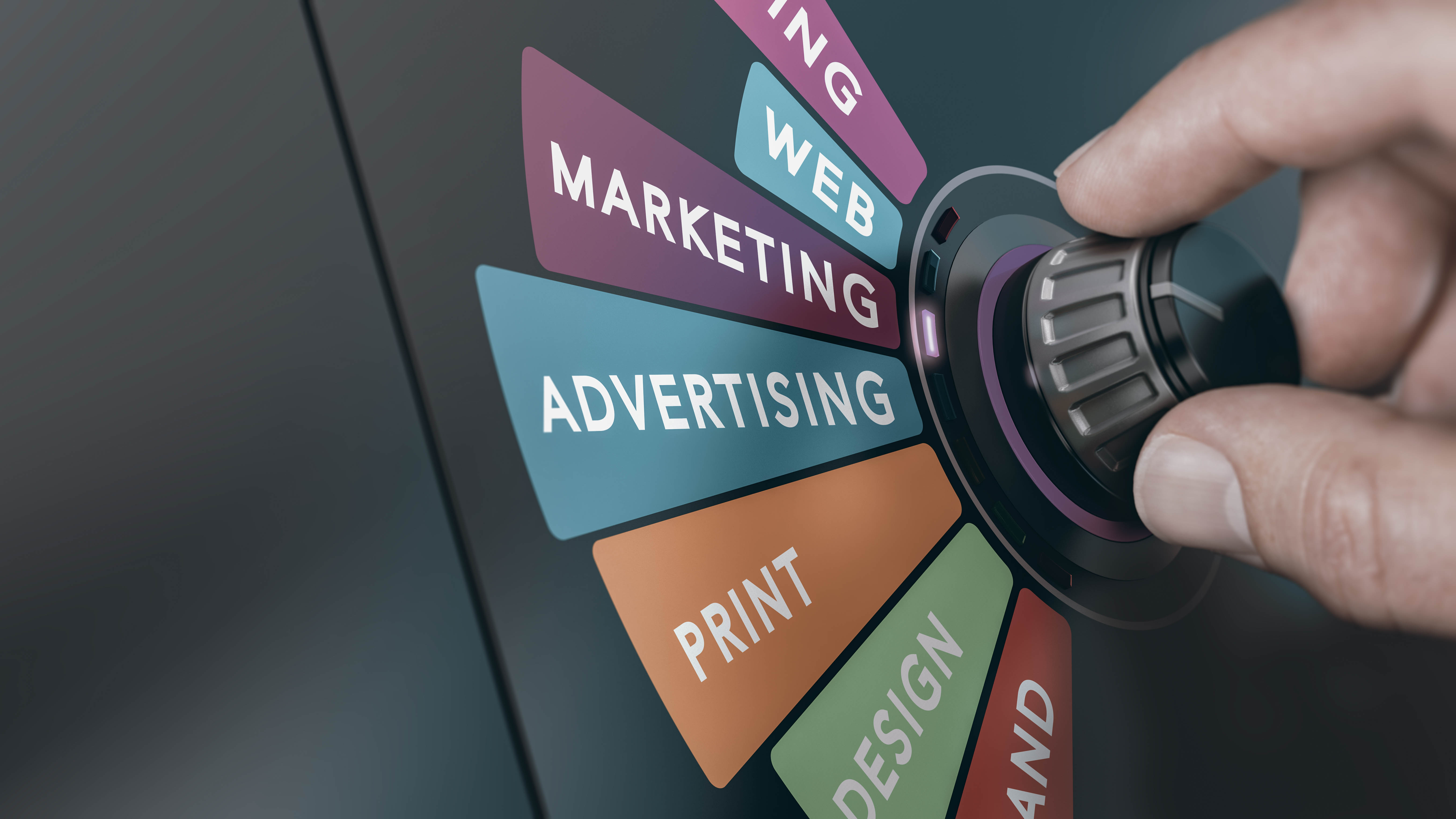 Hand dreht einen Regler, der verschiedene Bereiche wie Marketing, Werbung und Design anzeigt.